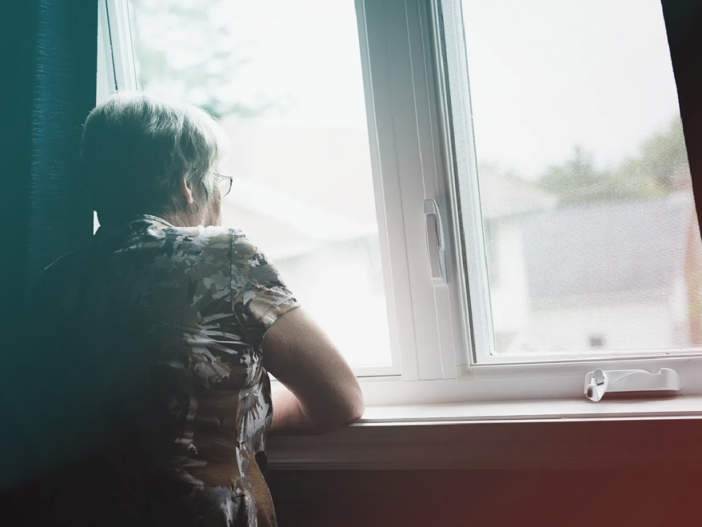 Older woman looking out the window